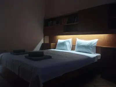 a bedroom with a bed with white sheets and pillows at Central Vintage Apartment for 4 Guests & Private Parking in Plovdiv