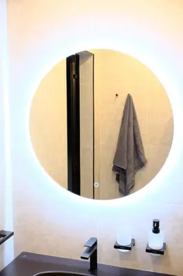 a mirror above a bathroom sink with a towel at Eleve Residences - Obsidian Studios in Sofia