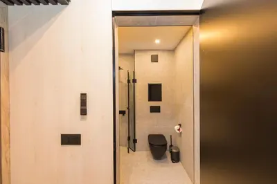 a door leading into a bathroom with a toilet at Eleve Residences - Obsidian Studios in Sofia