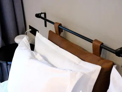 a close up of a bed with white pillows at Eleve Residences - Obsidian Studios in Sofia