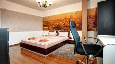 a bedroom with a bed and a painting on the wall at River Apartment in Sofia