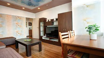 a living room with a couch and a table and a television at River Apartment in Sofia