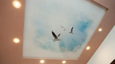 three birds flying in the sky on a ceiling at River Apartment in Sofia