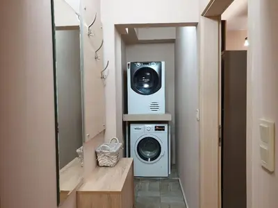 a laundry room with a washer and dryer in it at Уютнен апартамент Лагера in Sofia