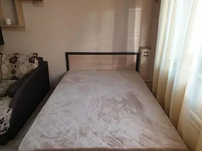 a small bed in a room with a window at Уютнен апартамент Лагера in Sofia