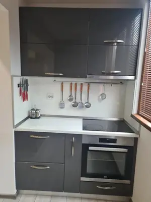 a kitchen with black cabinets and a stove top oven at Cosmopolitan in Devin