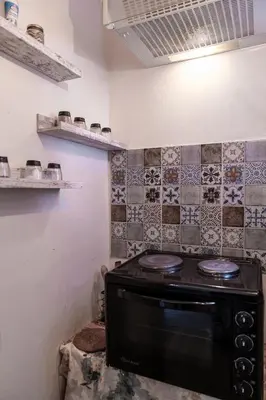 a stove in a kitchen with tiles on the wall at Teo's Cozy Top Central Apartment in Sofia