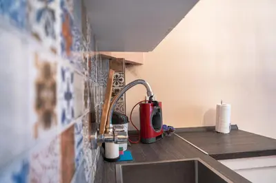 a kitchen sink with a toaster and a counter at Teo's Cozy Top Central Apartment in Sofia