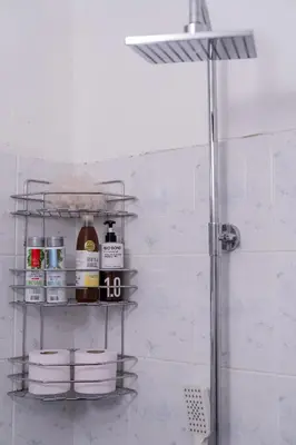 a bathroom with a shower and shelves with towels at Teo's Cozy Top Central Apartment in Sofia