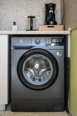 a washing machine in a kitchen with a counter at Skyline Studio in Sofia