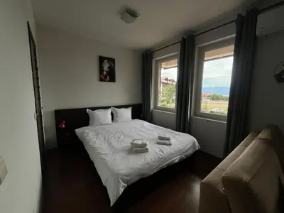 a bedroom with a bed with two glasses on it at Spacious Studio - Bansko Royal Towers in Bansko