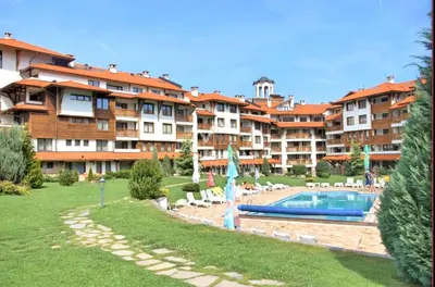 a large apartment complex with a swimming pool and a resort at Spacious Studio - Bansko Royal Towers in Bansko