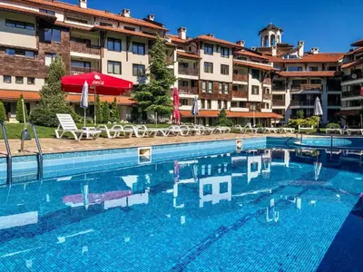 a large swimming pool in front of a hotel at Spacious Studio - Bansko Royal Towers in Bansko