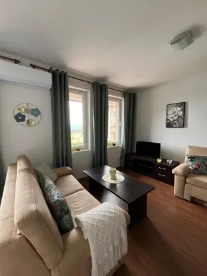 a living room with a couch and a coffee table at Spacious Studio - Bansko Royal Towers in Bansko