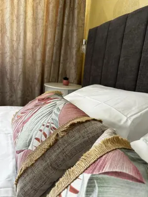 a close up of a bed with a blanket on it at Rea Flora - Cozy Stay With Free Parking in Sofia