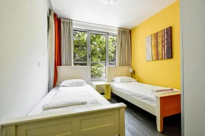 two beds in a room with a window at Joy Apartment - Stylish 2BD in Oborishte by Flat Mаnager in Sofia