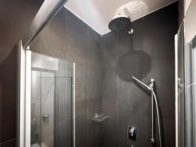a bathroom with a shower with a glass door at Joy Apartment - Stylish 2BD in Oborishte by Flat Mаnager in Sofia