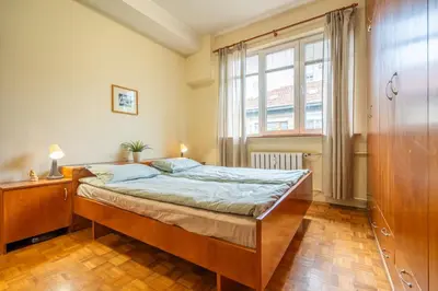 a bedroom with a bed and a large window at Spacious and Central Retreat in Sofia