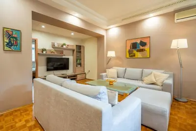 a living room with a couch and a table at Spacious and Central Retreat in Sofia
