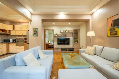 a living room with a couch and a table at Spacious and Central Retreat in Sofia