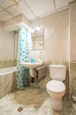 a bathroom with a toilet and a sink at Spacious and Central Retreat in Sofia