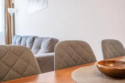 a table with chairs and a bowl on top of it at Belvedere Bansko - Cozy 1BR - Ski in Winter, Swim in Summer! by Flat Mаnаger in Bansko