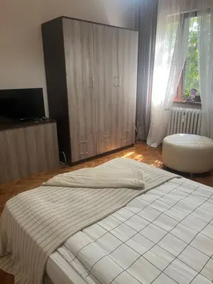 a bedroom with a large white bed and a window at Dunav 11 in Sofia