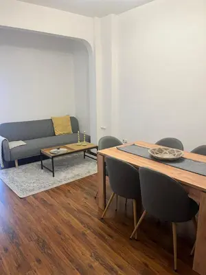 a living room with a table and a couch at Dunav 11 in Sofia