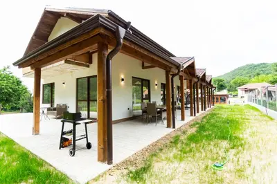 a pavilion with wooden posts on a house at Forest Nest in Krayni Dol