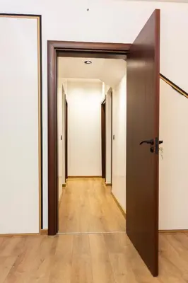 an open door to a hallway with white walls and wooden floors at Forest Nest in Krayni Dol