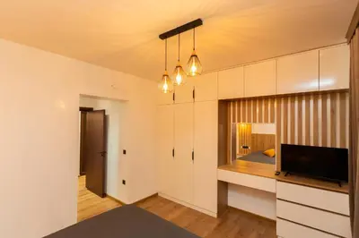 a living room with a bed and a television in it at Forest Nest in Krayni Dol