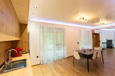a kitchen and dining room with a table and chairs at Forest Nest in Krayni Dol