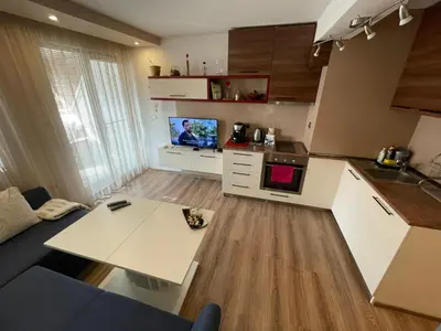 a kitchen with a couch and a table in a room at Premium Nomad's Suite-Near Subway-Terrace in Sofia