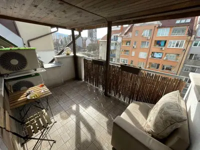 a balcony with a couch and a heater on a building at Premium Nomad's Suite-Near Subway-Terrace in Sofia