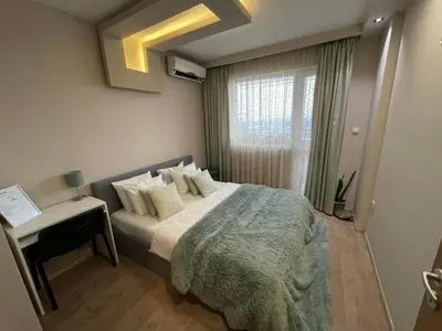 a small bedroom with a bed and a window at Premium High Rise, Gorgeous City Views in Plovdiv