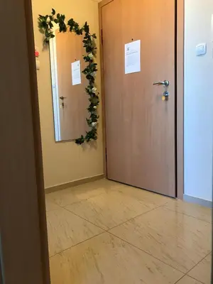 a hallway with a door with a wreath on it at Premium High Rise, Gorgeous City Views in Plovdiv