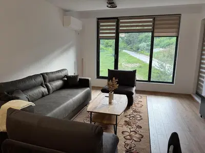 a living room with a couch and a table at Nikol5 Deluxe in Velingrad