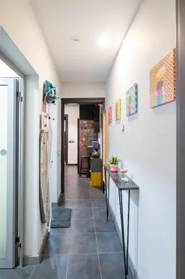 a hallway with a tile floor and white walls at Urban Oasis Heaven in Sofia