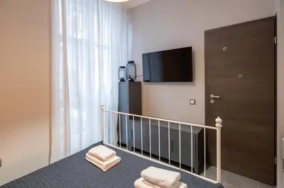 a room with a staircase with a tv and a door at Urban Oasis Heaven in Sofia