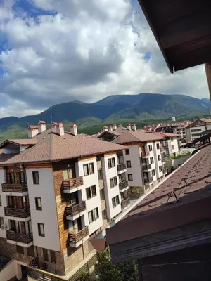 a view of a city with buildings and mountains at Топ локация! in Bansko