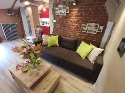a living room with a couch and a brick wall at D1 LOFT-Top center with free parking in Sofia