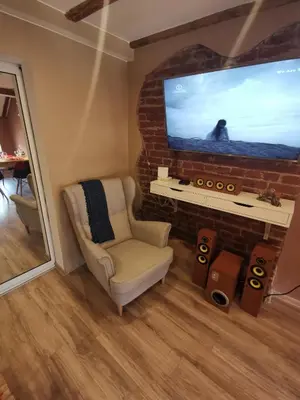 a living room with a chair and a large tv at D1 LOFT-Top center with free parking in Sofia