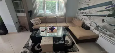 a living room with a couch and a coffee table at Къща за гости Спирката 2 in Hotovo