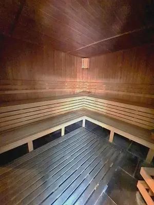 a empty room with a wooden floor in a room at Trinity Apartment & Pool with Spa Near Center in Bansko