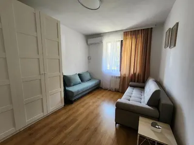 a living room with a couch and a table at Trinity Apartment & Pool with Spa Near Center in Bansko