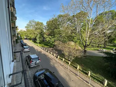 a street with cars parked on the side of a building at Park Apartment in Sofia