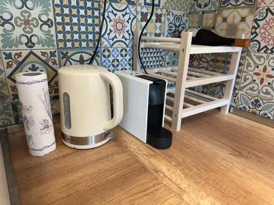 two coffeemakers sitting on the floor in a kitchen at Park Apartment in Sofia