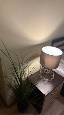 a chair sitting on a table next to a plant at Cosy apartment 11Mins Center in Plovdiv