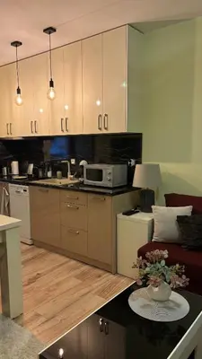 a kitchen with a couch and a table with a microwave at Cosy apartment 11Mins Center in Plovdiv