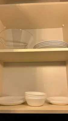 a shelf with plates and bowls in a closet at Cosy apartment 11Mins Center in Plovdiv